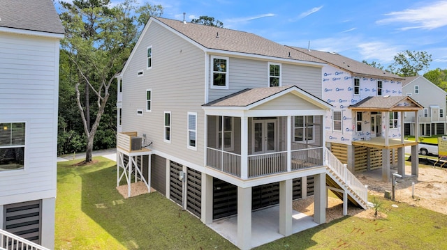 back of house with a sunroom, a yard, a patio, and central air condition unit