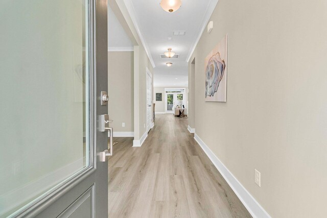 hall featuring light hardwood / wood-style floors and crown molding