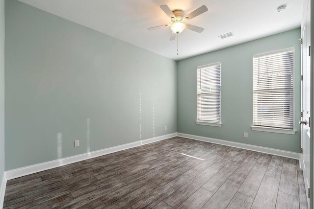 empty room with ceiling fan and dark hardwood / wood-style floors