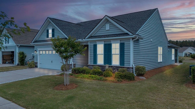 view of front of house featuring a lawn and a garage