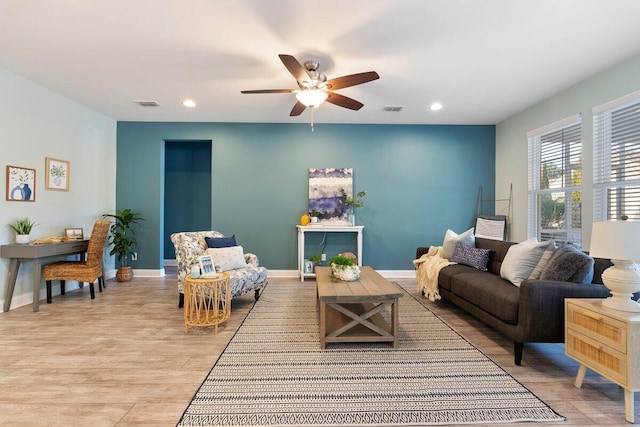 living room with ceiling fan and light wood-type flooring