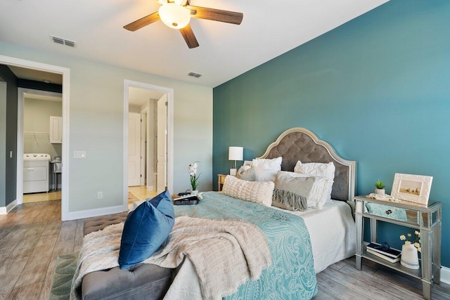 bedroom with washer / clothes dryer, ceiling fan, and wood-type flooring