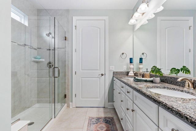 bathroom with an enclosed shower, tile patterned flooring, and vanity