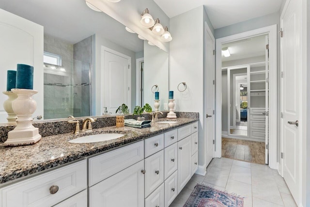 bathroom with vanity, tile patterned floors, and a shower with shower door