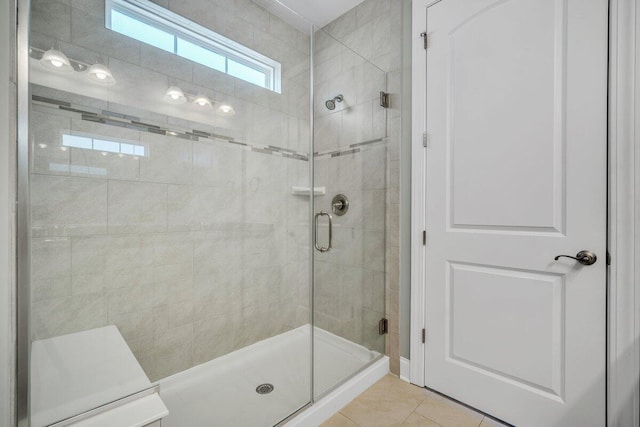 bathroom with tile patterned flooring and walk in shower