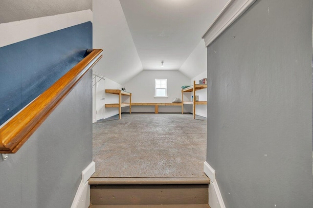 bonus room featuring lofted ceiling and carpet flooring