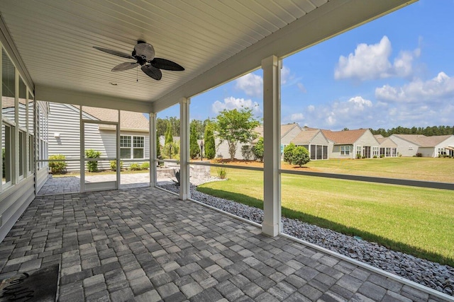 unfurnished sunroom with ceiling fan