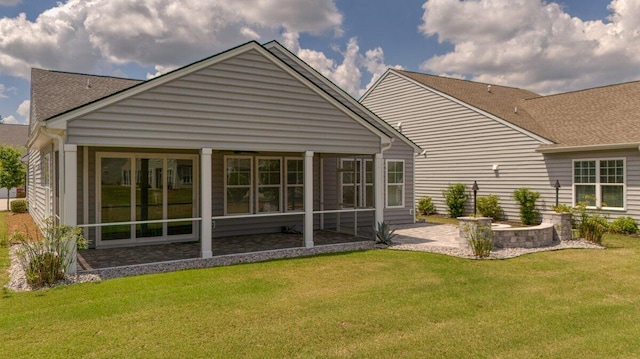 rear view of property with a lawn and a patio area