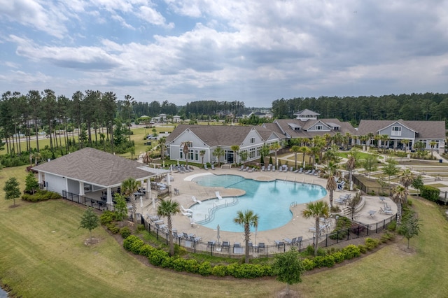 view of pool featuring a patio area and a yard