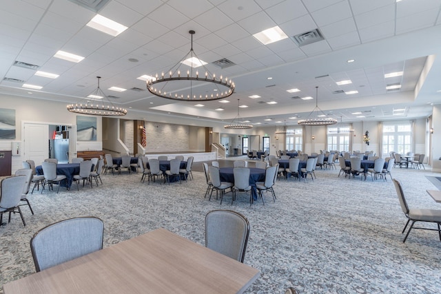 dining room with carpet flooring, a notable chandelier, and a paneled ceiling