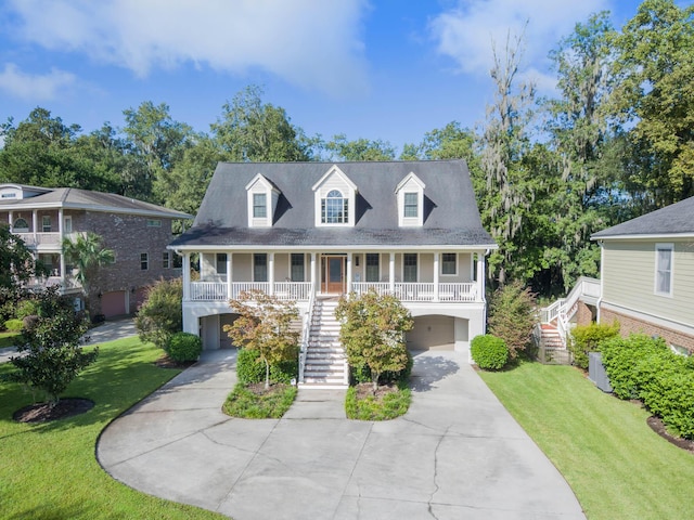 cape cod home featuring stairway, covered porch, concrete driveway, and a front yard