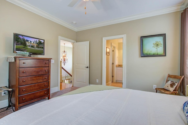 bedroom featuring crown molding, ensuite bath, a ceiling fan, and baseboards