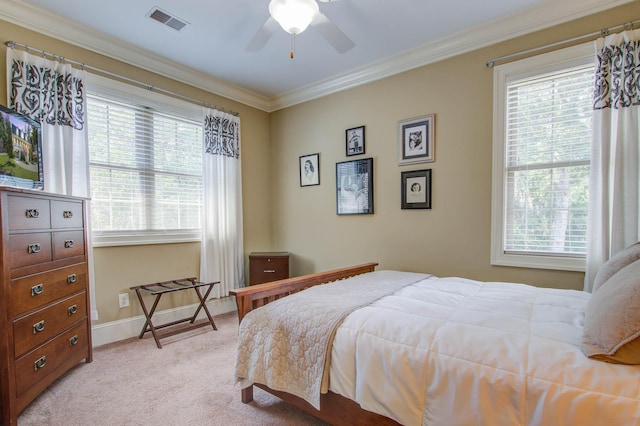 bedroom with light carpet, ornamental molding, baseboards, and a ceiling fan
