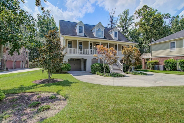 view of front of property with covered porch, stairs, concrete driveway, a front yard, and an attached garage