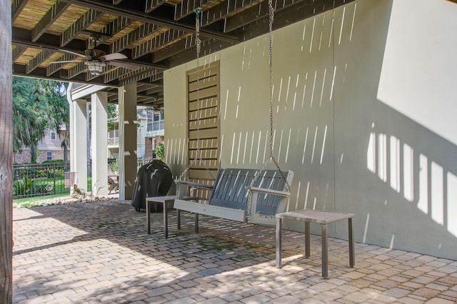 view of patio / terrace featuring ceiling fan and fence