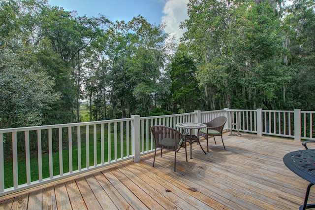 wooden terrace with view of scattered trees