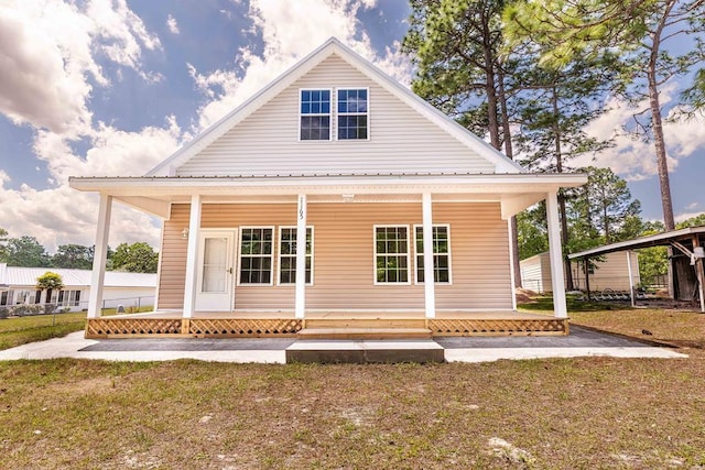 1165 Cleveland St, Elloree, SC 29047 - rear view of house featuring a porch and a lawn