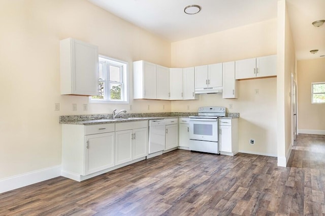 1165 Cleveland St, Elloree, SC 29047 - kitchen with white appliances, under cabinet range hood, dark wood-style flooring, white cabinets, and baseboards