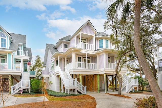 raised beach house featuring a carport and a porch