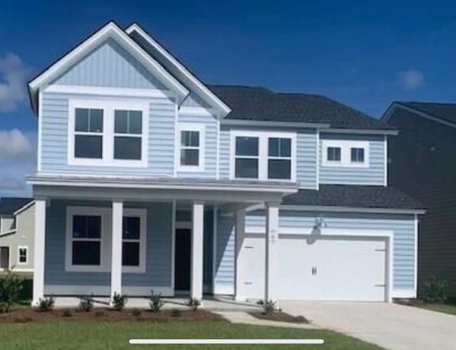 view of front facade featuring covered porch, a garage, driveway, board and batten siding, and a front yard