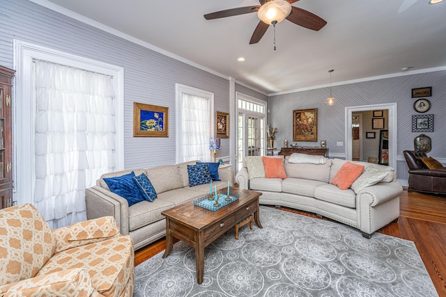 living area with wood finished floors, recessed lighting, ornamental molding, and ceiling fan