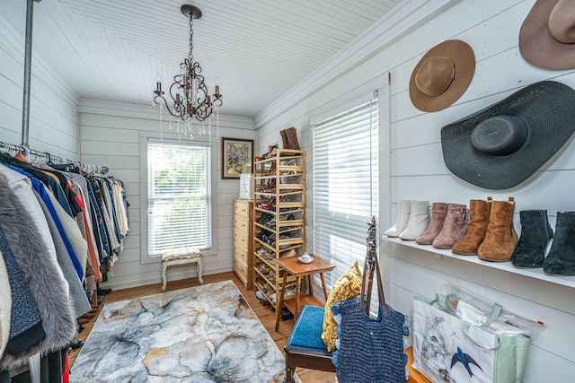 spacious closet featuring a notable chandelier and wood finished floors
