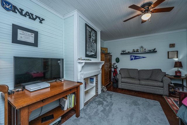 living area with crown molding, wood finished floors, ceiling fan, and wooden ceiling