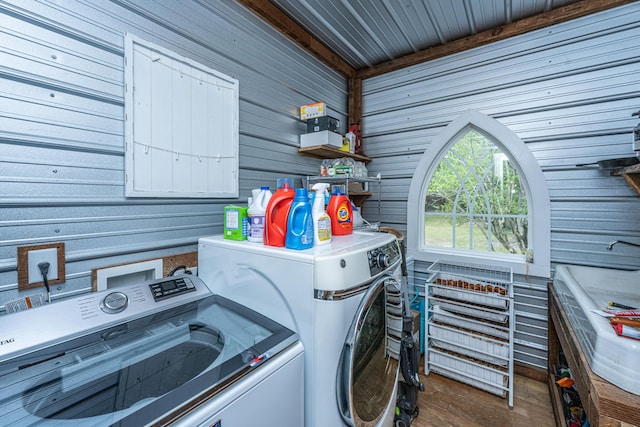 clothes washing area featuring independent washer and dryer, laundry area, and wood finished floors