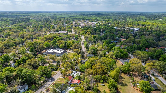 birds eye view of property with a view of trees
