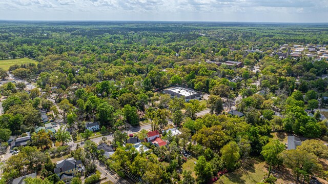 drone / aerial view featuring a forest view and a residential view