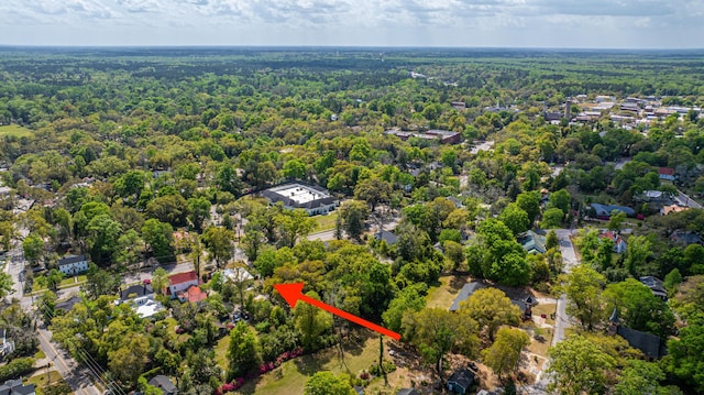 birds eye view of property with a view of trees