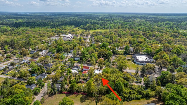 birds eye view of property featuring a view of trees