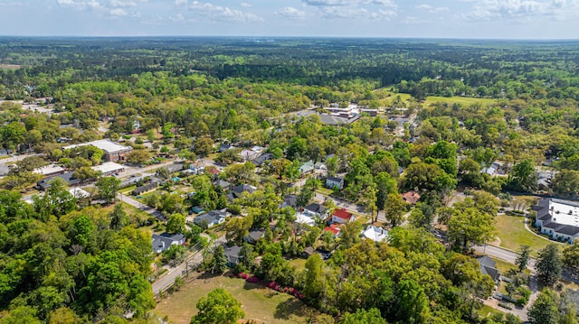drone / aerial view with a wooded view