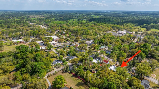 birds eye view of property featuring a wooded view
