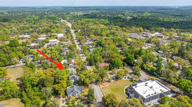 bird's eye view with a wooded view