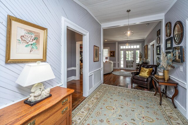 entrance foyer featuring crown molding and wood finished floors