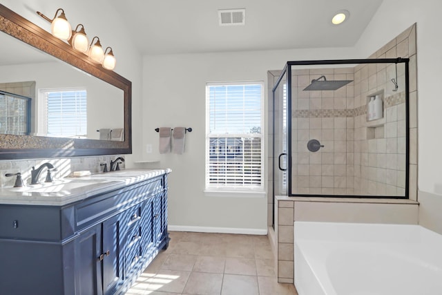 bathroom featuring vanity, separate shower and tub, a healthy amount of sunlight, and tile patterned floors