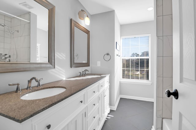 bathroom featuring vanity, tiled shower, and tile patterned floors