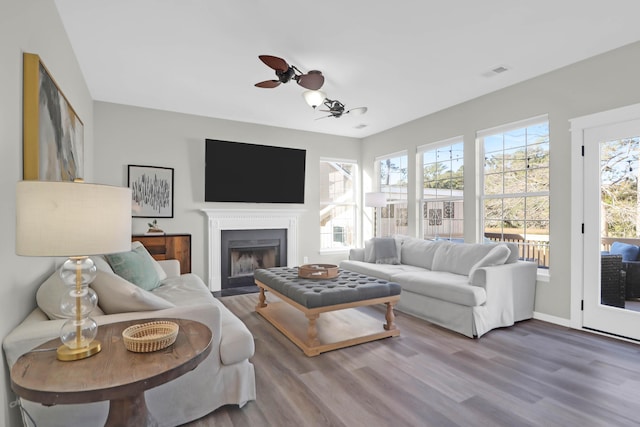 living room with hardwood / wood-style floors and ceiling fan