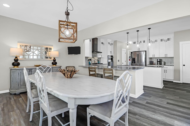 dining area featuring dark hardwood / wood-style floors and sink