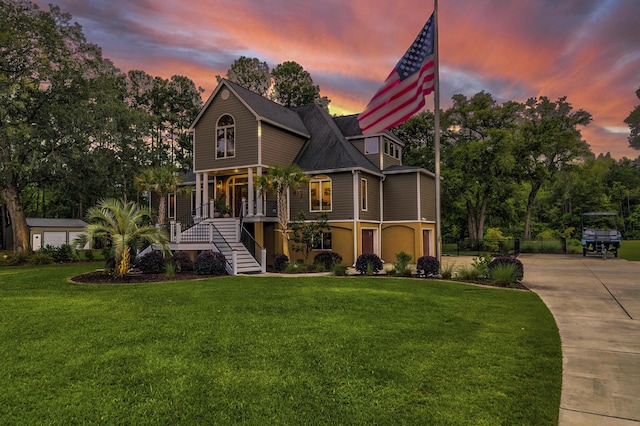 view of front of house featuring a yard and covered porch