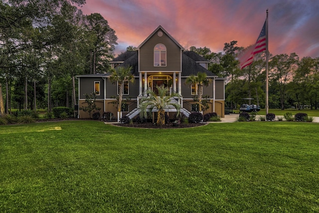 view of front of home with a porch and a lawn