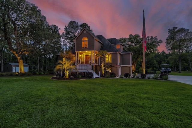 view of property with covered porch and a lawn