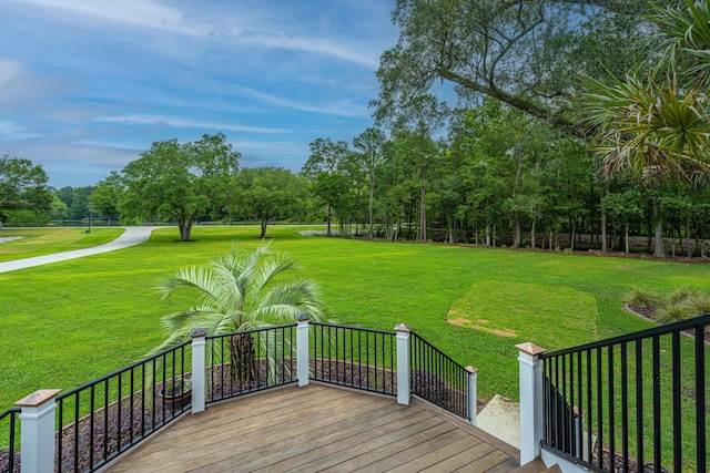 wooden terrace with a lawn