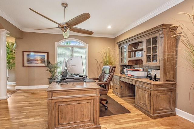 office space featuring ceiling fan, ornamental molding, decorative columns, and light hardwood / wood-style flooring