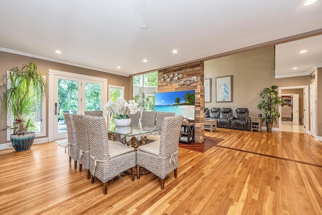 dining area with crown molding and light hardwood / wood-style flooring