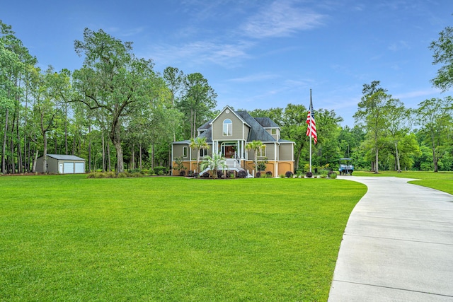 view of front of home with a front yard and a storage unit