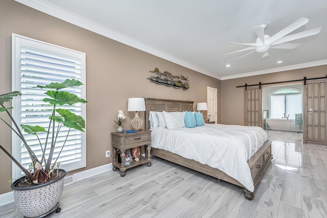 bedroom featuring ceiling fan, a barn door, multiple windows, and light hardwood / wood-style flooring