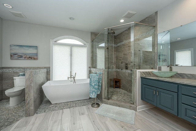 full bathroom with vanity, toilet, separate shower and tub, and wood-type flooring