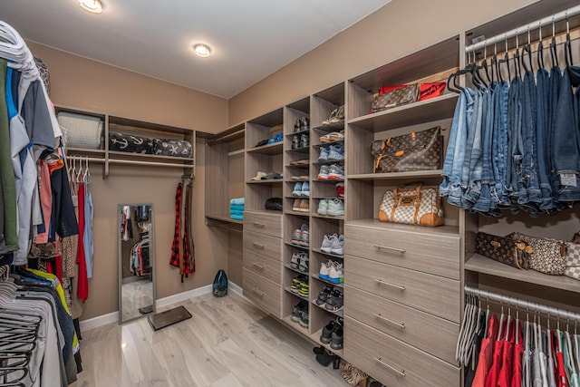 walk in closet featuring light hardwood / wood-style flooring